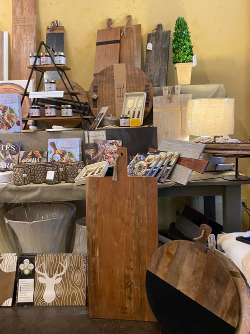 Display of wooden products and decor items in a store setting.